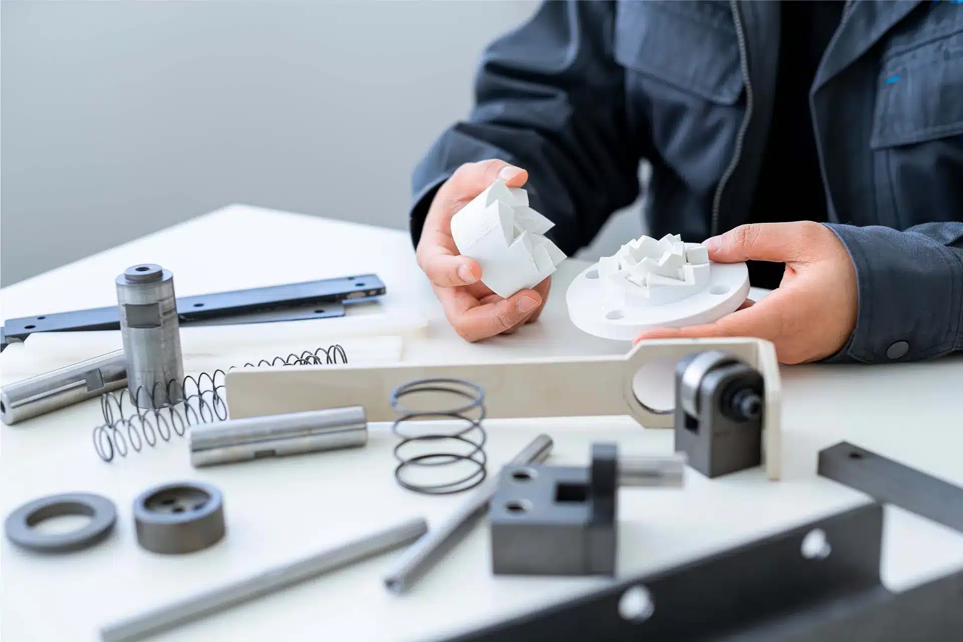 Technician reviewing spring prototypes and sample fixtures for rapid prototyping (Zigoal)