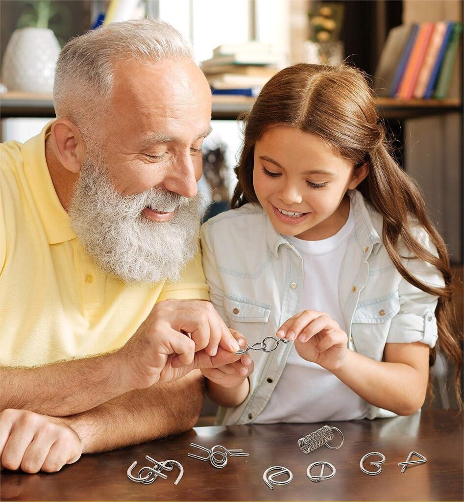Man and child solving metal wire puzzle rings, wire forms for IQ puzzles (Zigoal)