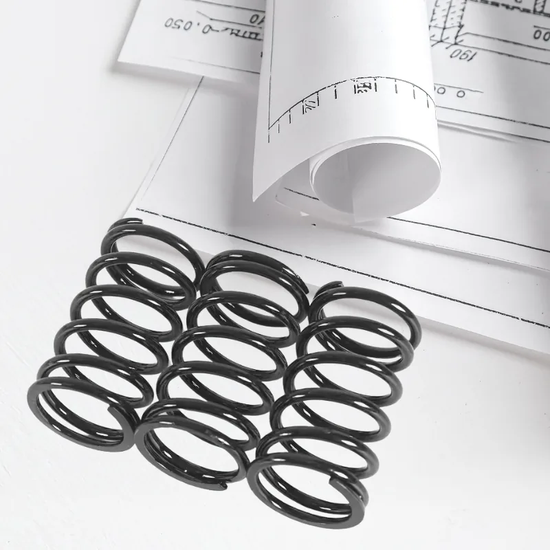 Custom Compression Spring Design Black compression springs on an engineering drawing, custom compression spring design (Zigoal)